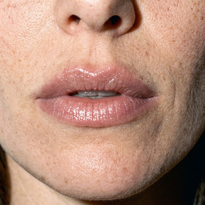 Close-up of bare, glossy lips