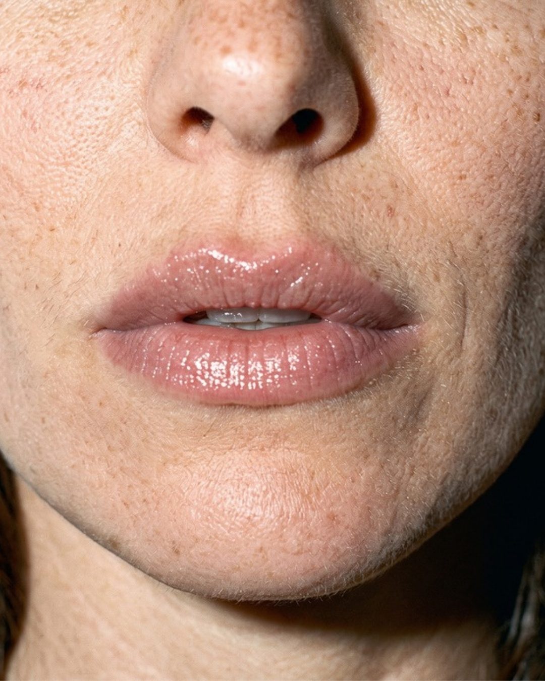 Close-up of bare, glossy lips